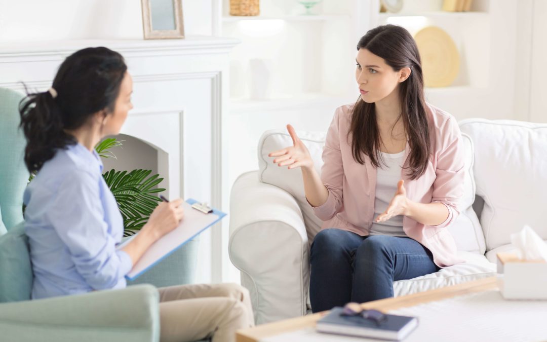 woman asking questions to a therapist at a treatment center