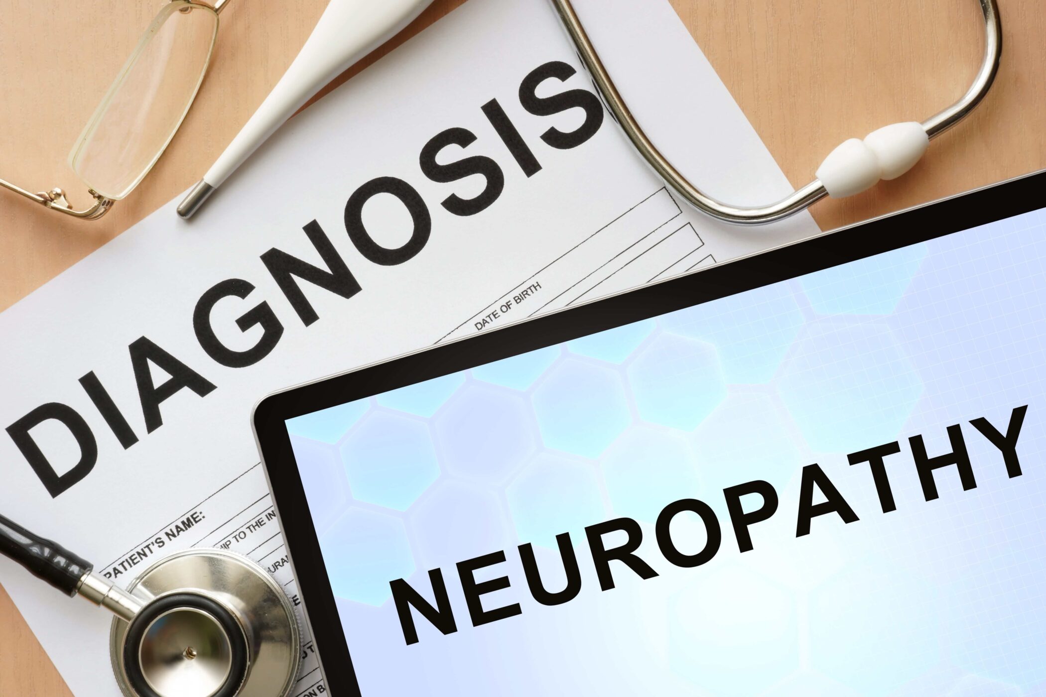 neuropathy diagnosis written on a tablet next to stethoscope