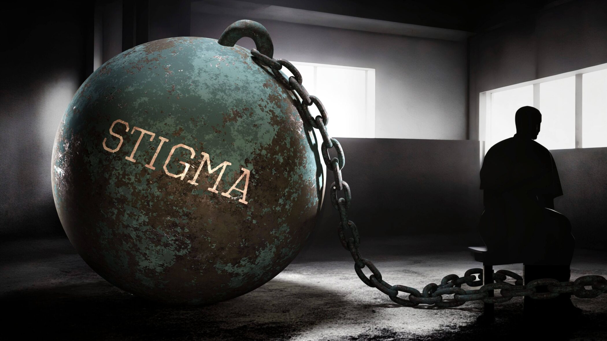man sitting in the dark tied to the word stigma