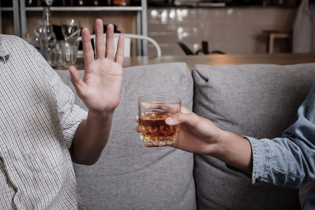 man refusing to drink alcohol