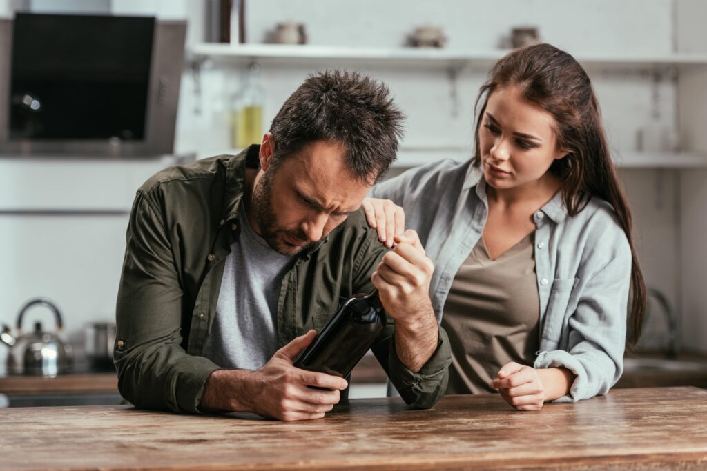woman supporting alcoholic spouse