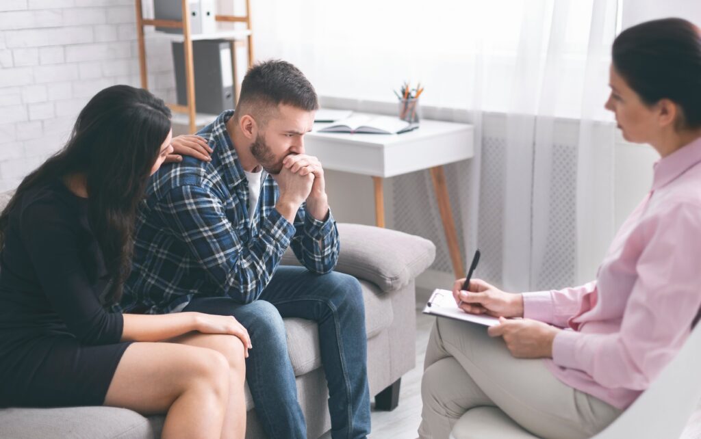 woman persuading man to go to rehab