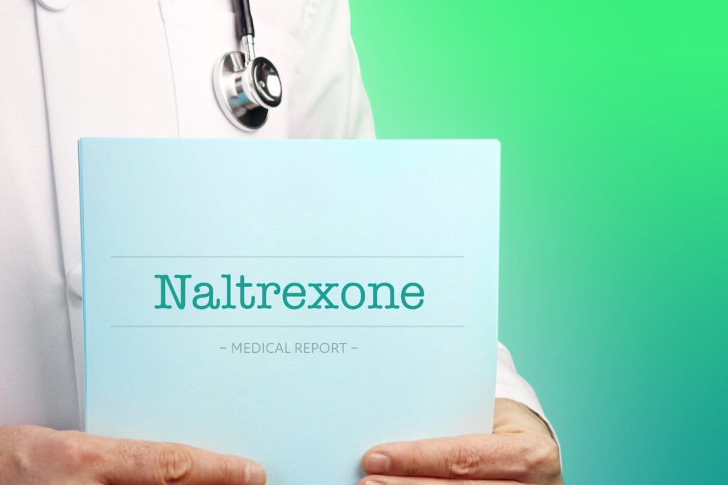 doctor holding up a sign that shows naltrexone