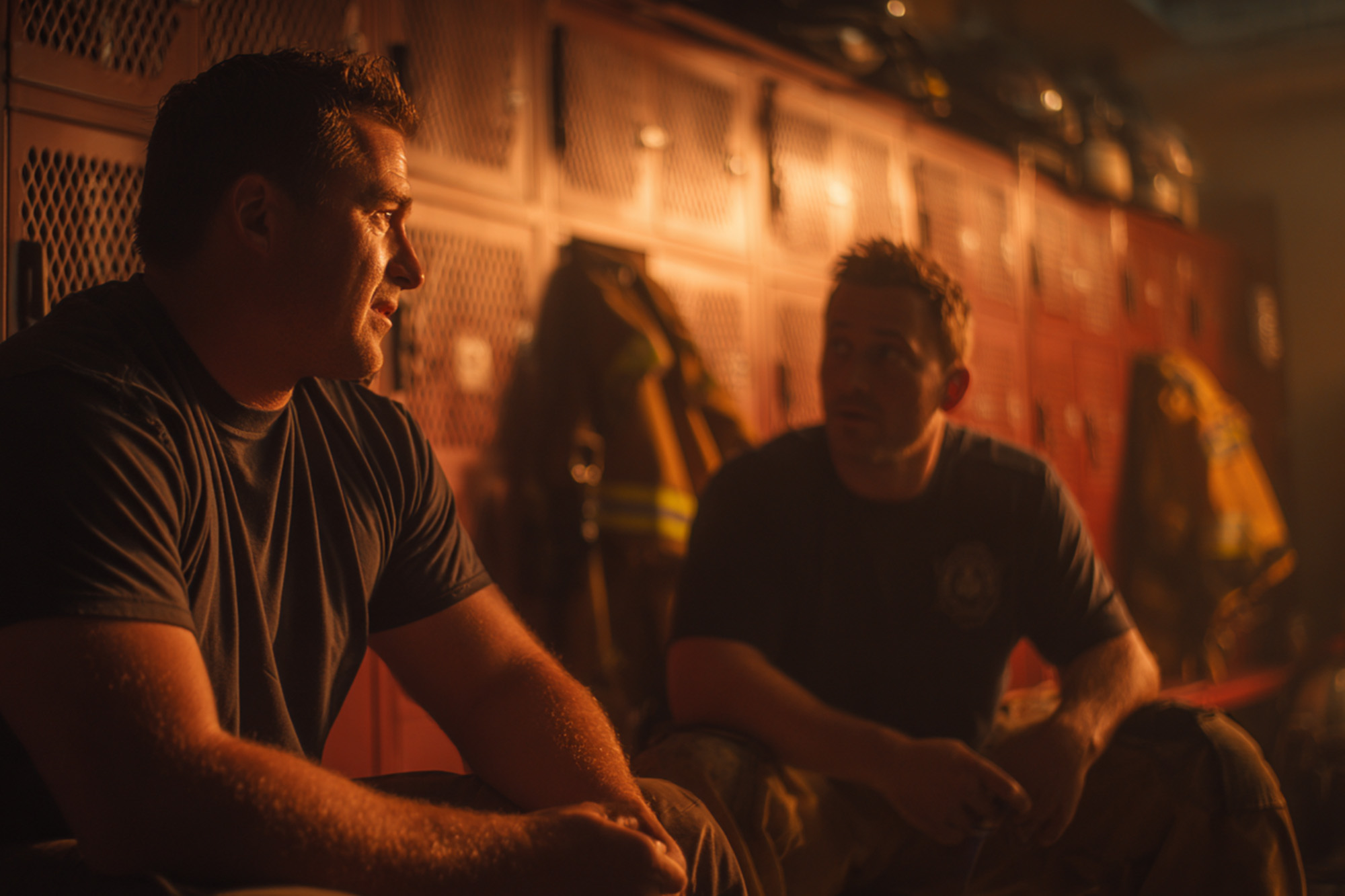 firefighter and paramedic sitting in firehouse lounge after shift, supportive conversation firefighter and paramedic sitting in firehouse lounge after shift, supportive conversation